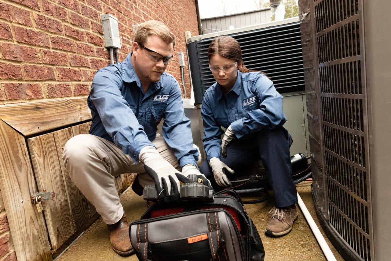 Lee Company technicians prepping to repair an HVAC system