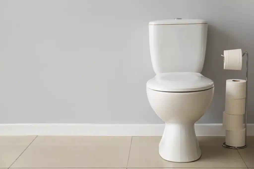 A toilet that runs randomly in a bathroom.
