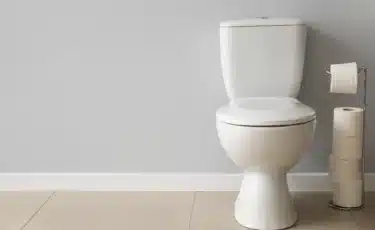 A toilet that runs randomly in a bathroom.