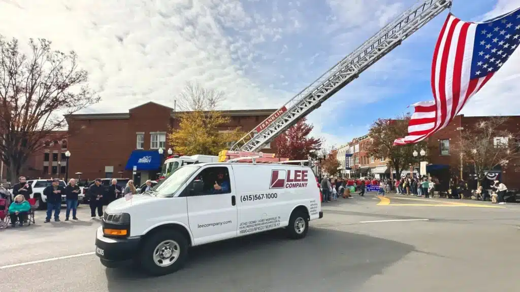 A Lee Company van with an American flag on top in support of veterans