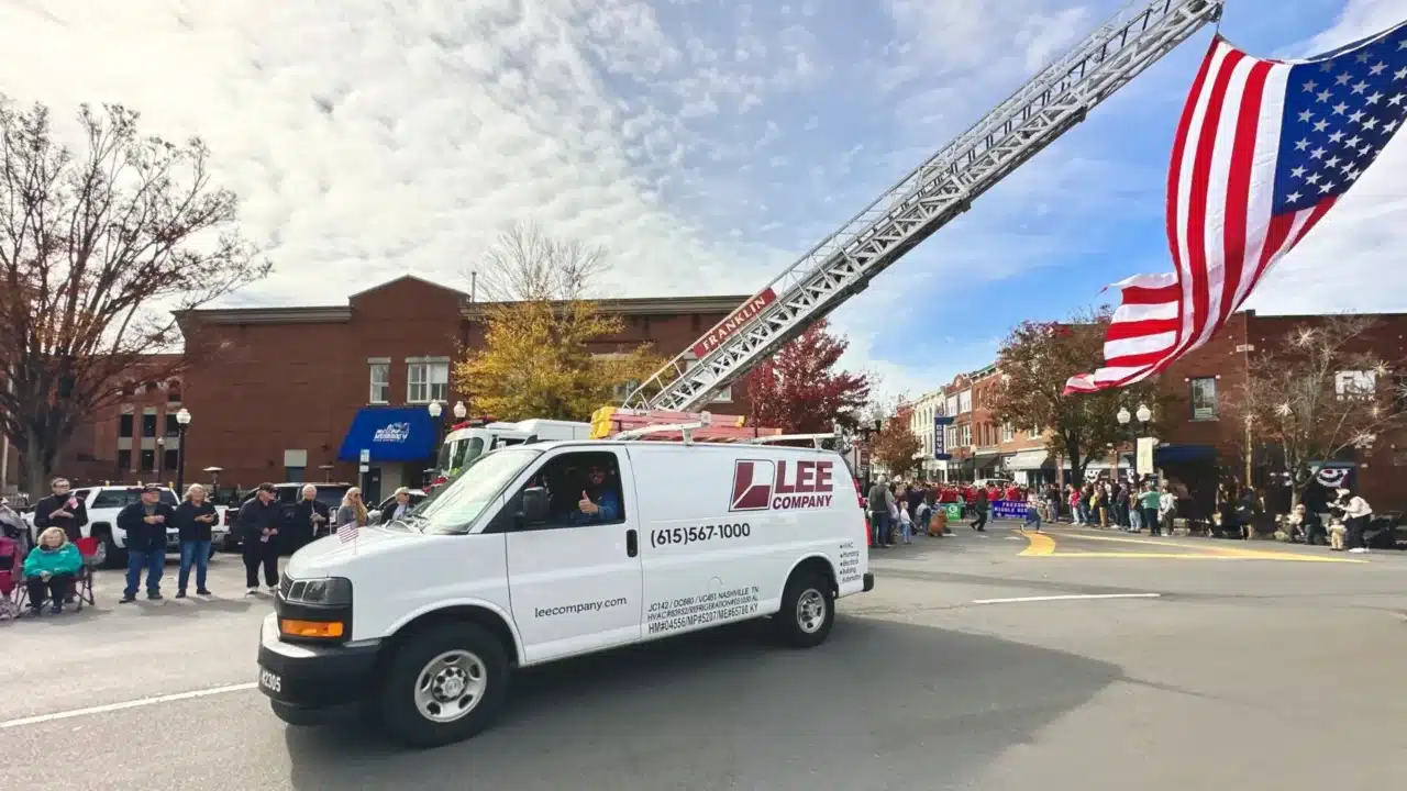 A Lee Company van with an American flag on top in support of veterans