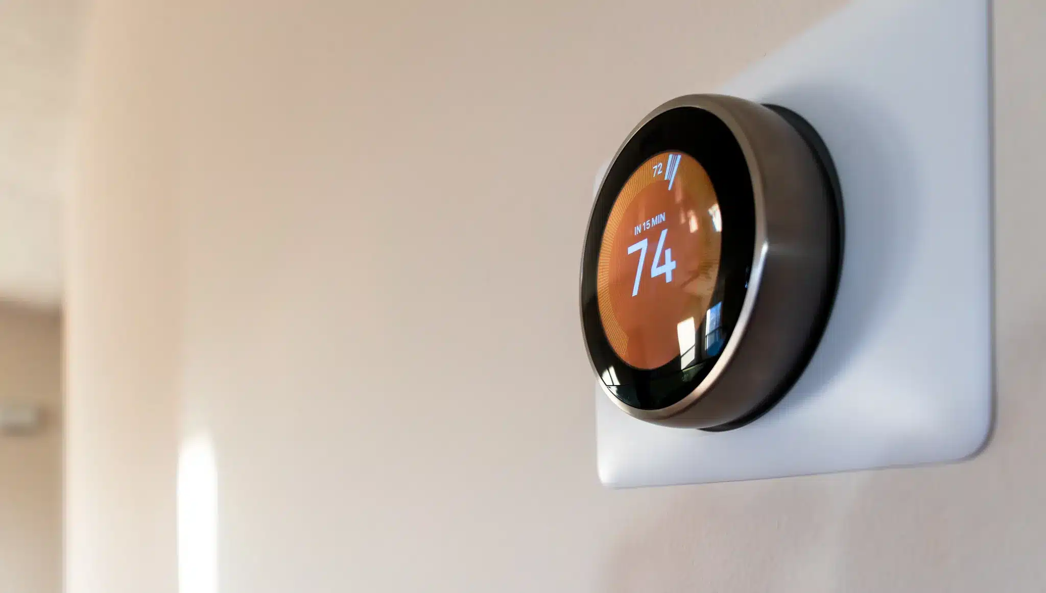 Nest thermostat on beige wall
