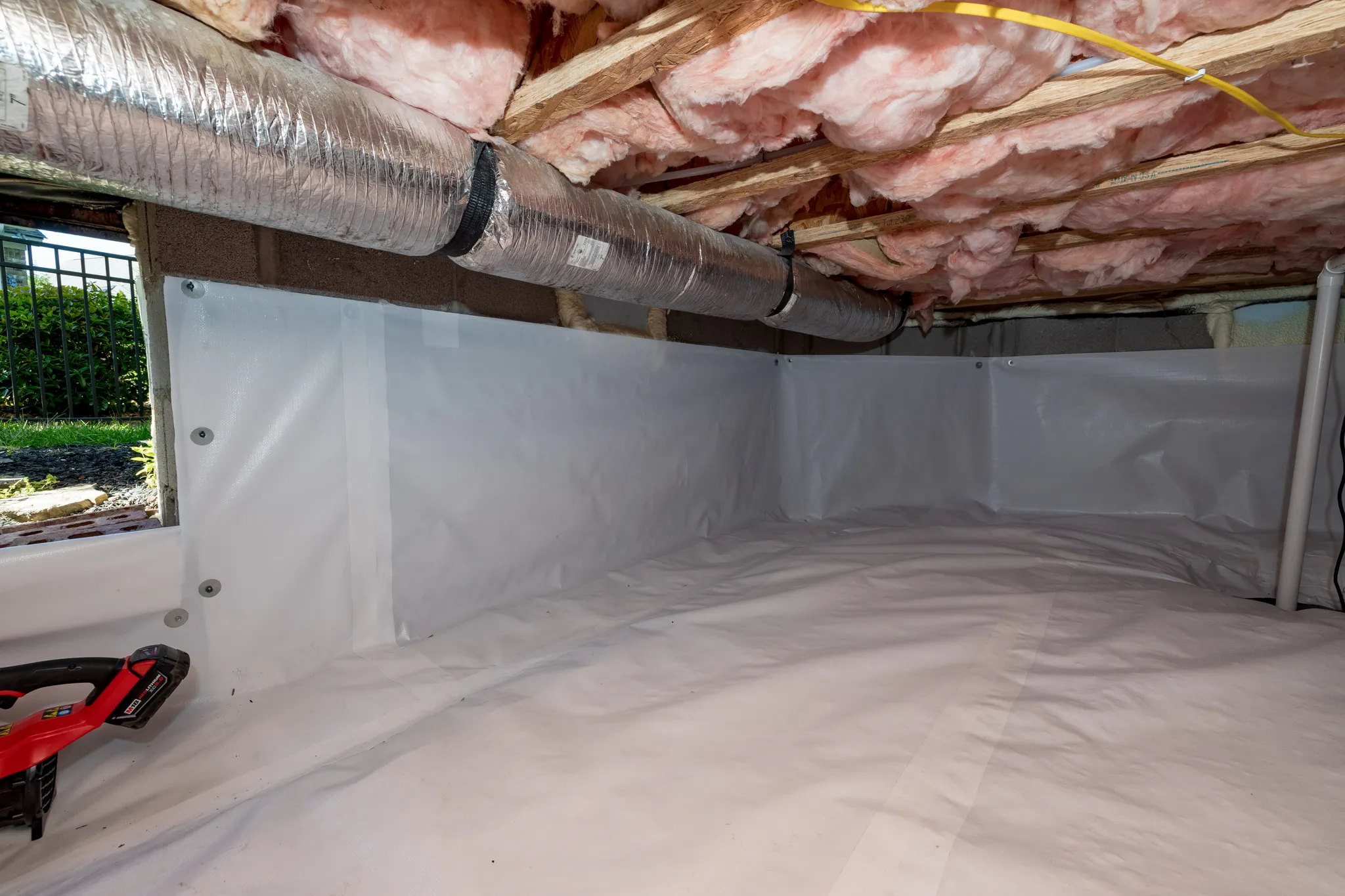 A photograph of a professional crawl space encapsulation performed by Lee Company in a home.